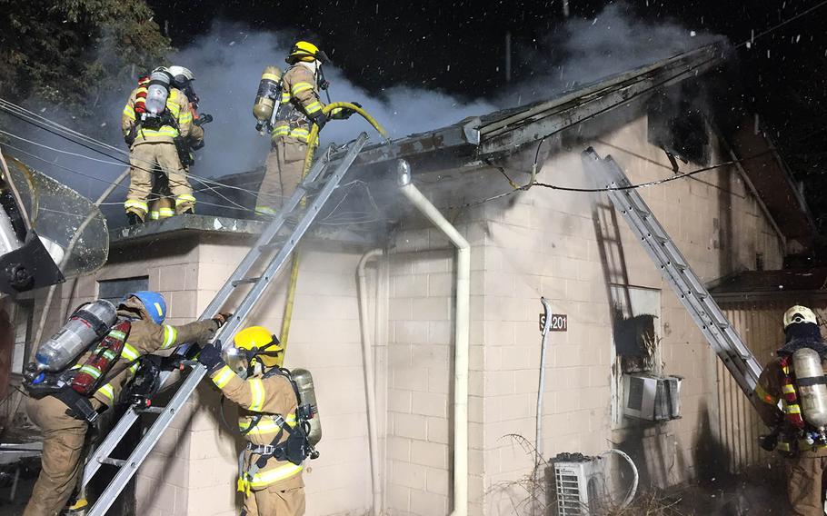 Firefighters battle a blaze at Yongsan Garrison, South Korea, Monday, Dec. 18, 2017.