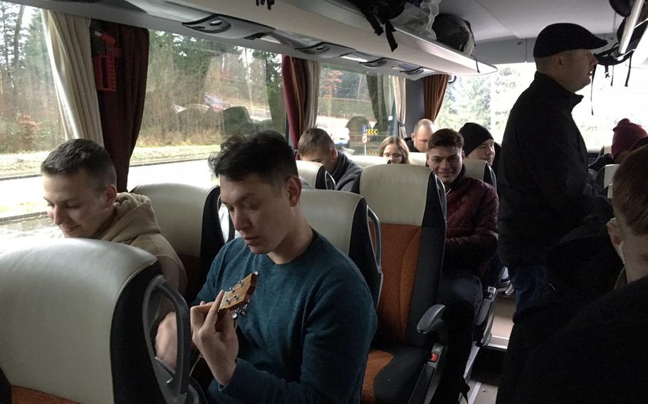 Capt. Leon Buchanan, a chaplain from the Grafenwoehr Training Area, plays a ukulele on the bus that brought soldiers and families to Bastogne, Belgium, Saturday, Dec. 16, 2017.