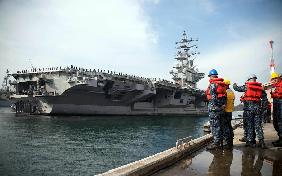 The aircraft carrier USS Ronald Reagan approaches a pier at Yokosuka Naval Base, Japan, Dec. 4, 2017.