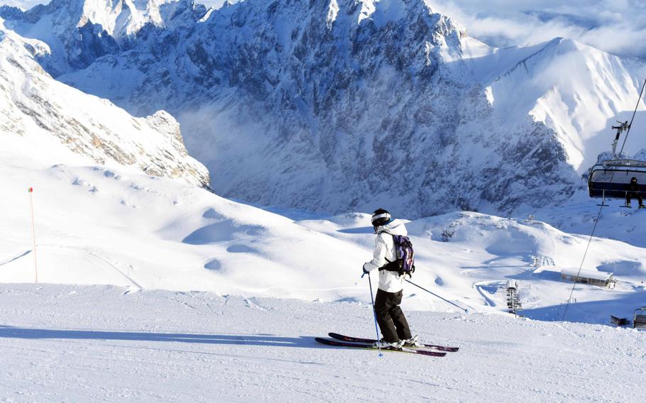 A skier peers over a cliff on the Zugspitze, Germany's tallest mountain, near Garmisch, Germany, Tuesday, Dec. 19, 2017.