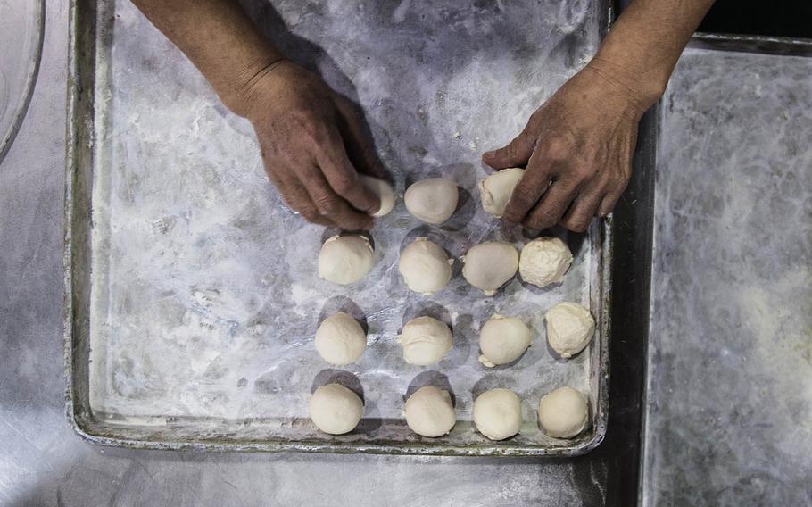 A baker makes pastries at the Army and Air Force Exchange Service bakery at Camp Market, South Korea, Tuesday, Dec. 5, 2017.