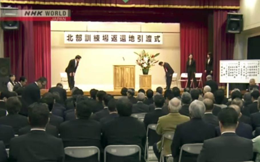 Japanese officials hold a ceremony in the Okinawan village of Kunigami to celebrate the official return of land from the Northern Training Area, Monday, Dec. 25, 2017.