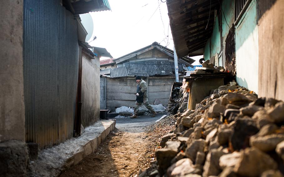 A soldier from 1st Battalion, 38th Field Artillery Regiment walks through an alley in Yeoncheon, South Korea, Thursday, Dec. 28, 2017.
