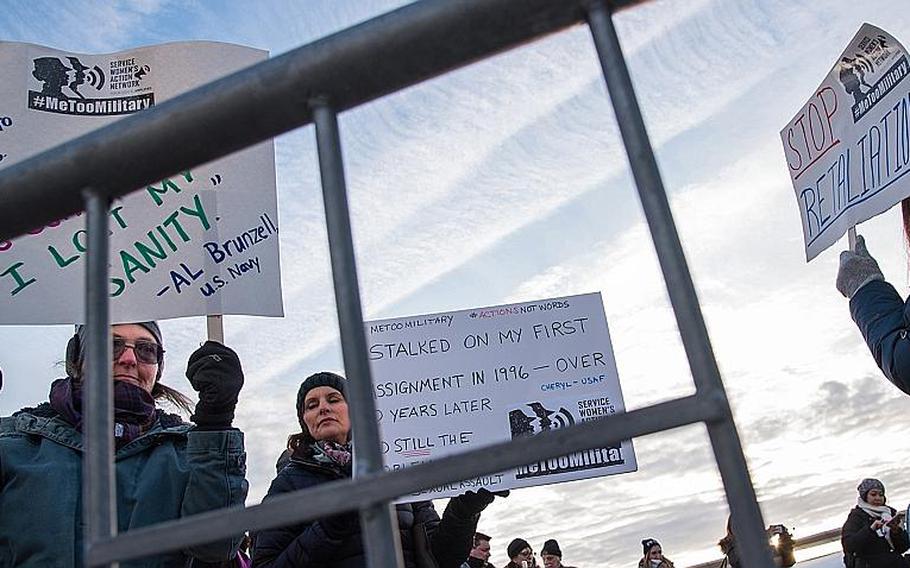 Women hold signs protesting the military's response to sexual harassment and assault outside the Pentagon Monday, Jan. 8, 2018 during the Service Women's Action Network-organized #metoomilitary Stand Down.