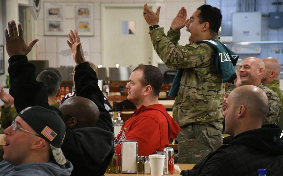 Army Sgt. Oscar Ortiz, standing, and other football fans at NATO's headquarters in Kabul celebrate after the Philadelphia Eagles score a touchdown during the 2018 Super Bowl on Monday, Feb. 5, 2018.