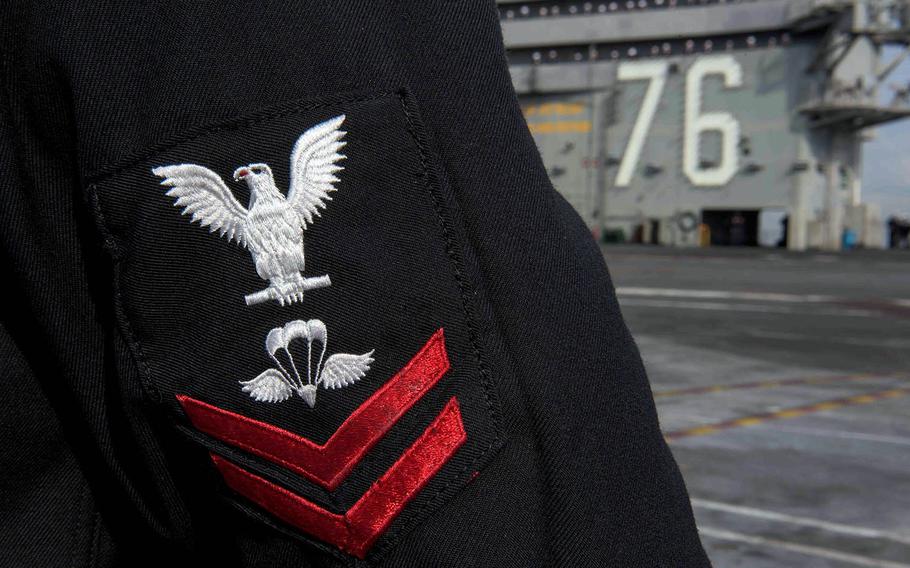 A sailor mans the rails as the USS Ronald Reagan arrives at Yokosuka Naval Base, Japan, Dec. 4, 2017.