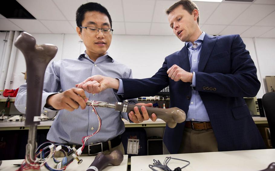 Jerome Lynch, right, an engineering professor at the University of Michigan, discusses the results of an experiment with research fellow Wentao Wang, Sept. 27, 2017. The Office of Naval Research is sponsoring Lynch's work as part of the Monitoring OsseoIntegrated Prostheses program, whose aim is to create a "smart" artificial leg equipped with specially designed sensors to monitor walking gait, alert users to prosthetic wear and tear, and warn of potential infection risk.