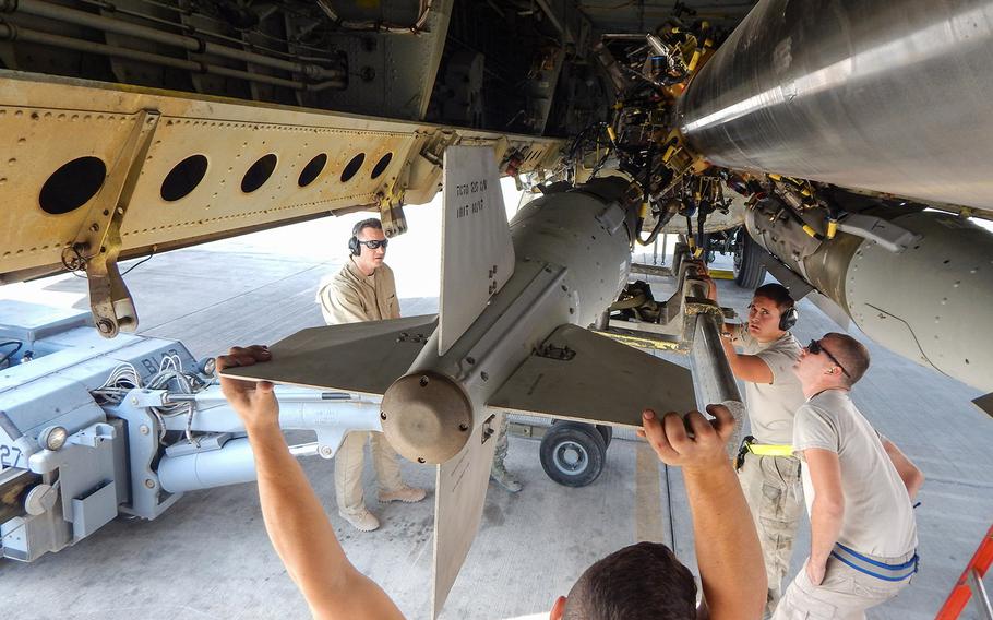 U.S. airmen with the 69th Expeditionary Bomber Squadron load smart bombs for the first time on the conventional rotary launcher of a B-52 Stratofortress, at Al Udeid Air Base, Qatar, Nov. 11, 2017.