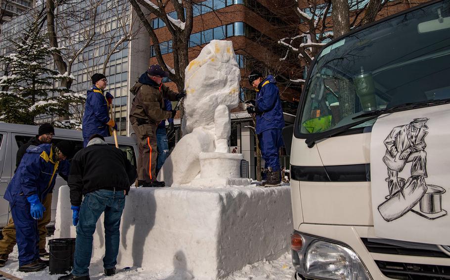 Sailors from Naval Air Facility Misawa work on a sculpture for the 69th annual Sapporo Snow Festival in Hokkaido, Japan, Jan. 31, 2018.