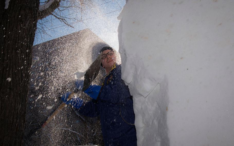 Kyle Antrobus works Naval Air Facility Misawa's sculpture for the 69th annual Sapporo Snow Festival in Hokkaido, Japan, Jan. 30, 2018.