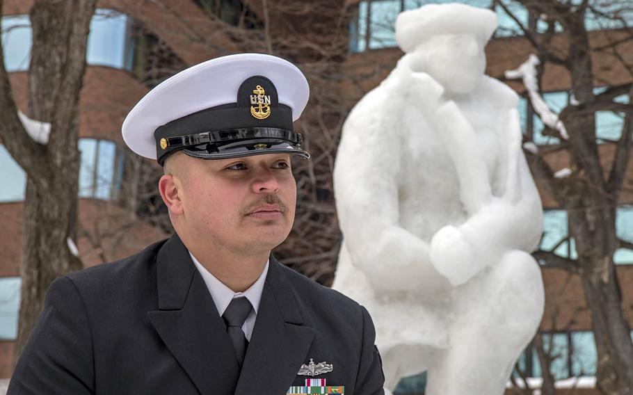 Chief Alberto Martinez of the guided-missile destroyer USS Mustin poses with Naval Air Facility Misawa's contribution to the 69th annual Sapporo Snow Festival, Feb. 3, 2018.