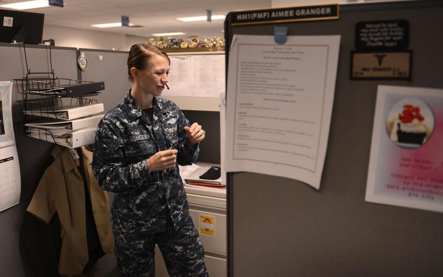 Hospital Corpsman 1st Class Aimee Granger, a Hospital Corpsman detailer with Navy Personnel Command's Career Management Department, helps a Sailor with a detailing issue in Millington, Tenn., Feb. 4, 2016.