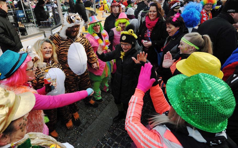 Revelers dance during the Weiberfastnacht, or women's carnival, celebrations in Mainz, Germany, Thursday, Feb. 8, 2018. Weiberfastnacht opens the final long weekend of the carnival season in Germany.