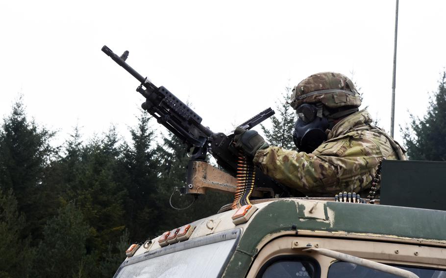 Staff Sgt. Daryl Carroll loads an M240 machine gun mounted to an M1120 HEMTT Load Handling System during live-fire training at Grafenwoehr, Germany, Thursday, Feb. 8, 2018.