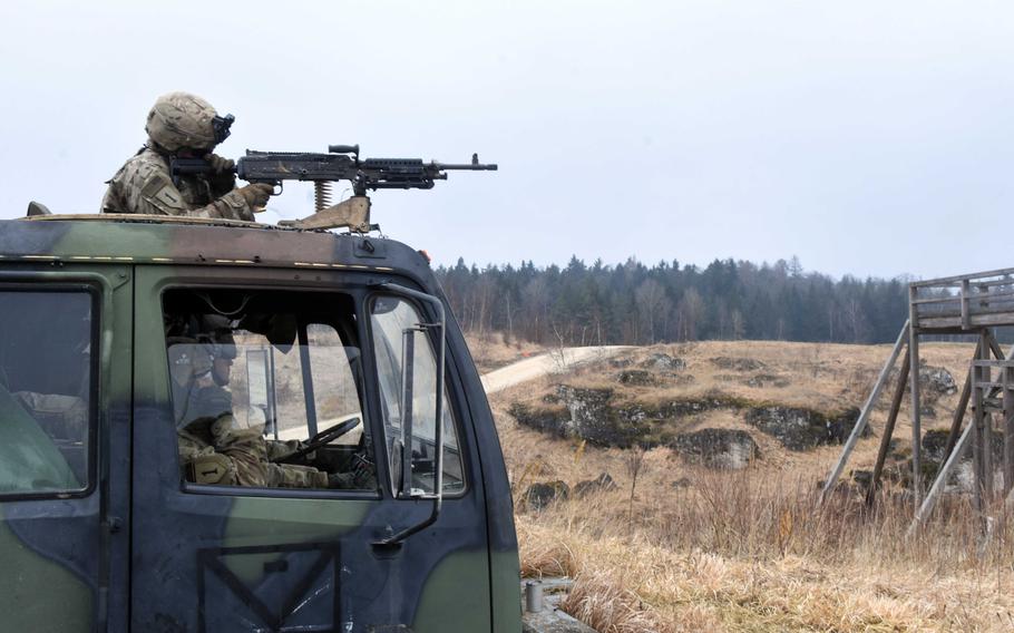 Sgt. John Kopeck fires an M240 machine gun mounted to an M1120 HEMTT Load Handling System during live-fire training at Grafenwoehr, Germany, Thursday, Feb. 8, 2018.