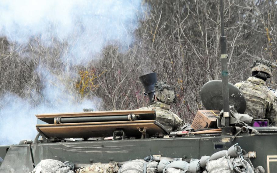 Soldiers with the 2nd Armored Brigade Combat Team fire a 120 mm mortar inside of an M113 mortar carrier, during live-fire training at Grafenwoehr, Germany, Thursday, Feb. 8, 2018.