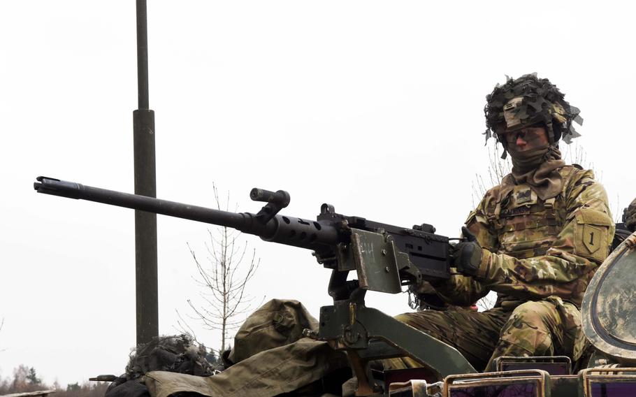 Pvt. Dylan Calkins mans a .50-caliber machine gun mounted to an M113 mortar carrier, during live-fire training at Grafenwoehr, Germany, Thursday, Feb. 8, 2018.