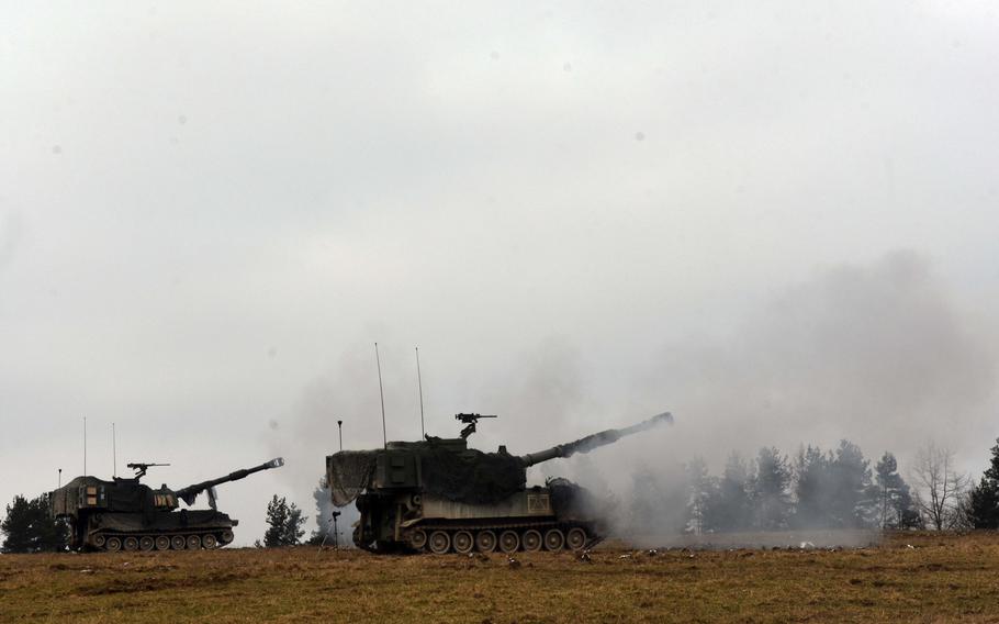 M109 Paladins fire during live-fire training at Grafenwoehr, Germany, Thursday, Feb. 8, 2018.