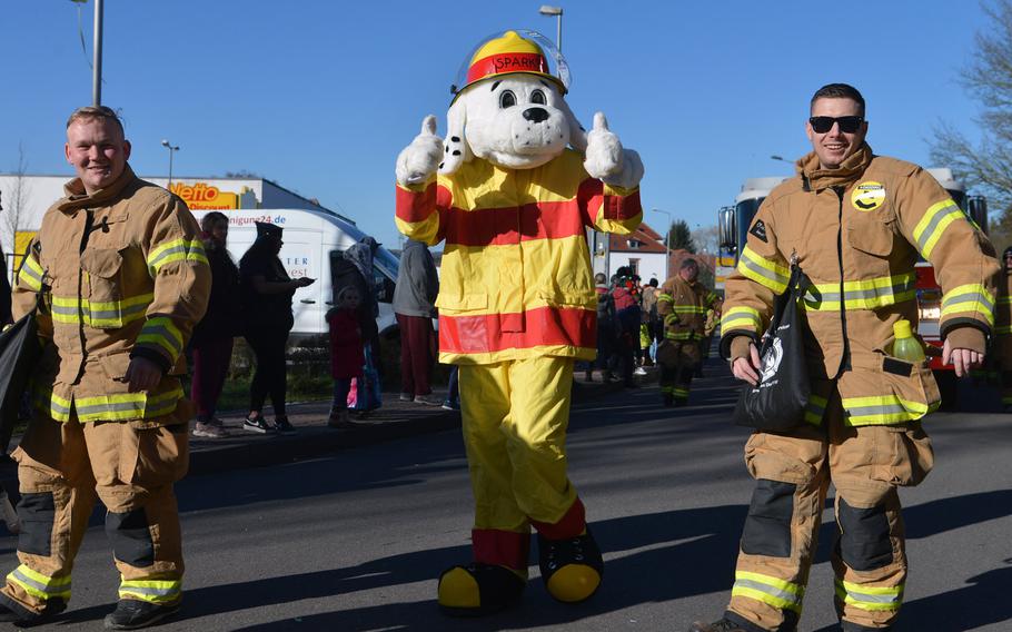 Sparki the Fire Dog and members of the KMC fire department greet the crowd lining the streets for the 67th annual Ramstein-Miesenbach Fasching parade Tuesday, Feb. 13, 2018.