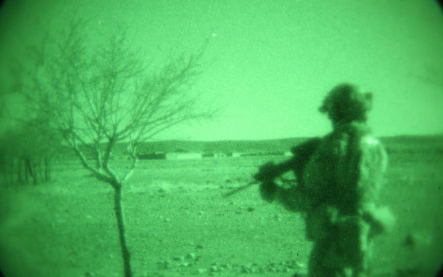 An commando guards a compound during the clearance of a village in Maiwand district, Kandahar province, in February 2014. A separate operation by Afghan forces in the district on Jan. 31, 2018, is alleged to have killed 20 people.