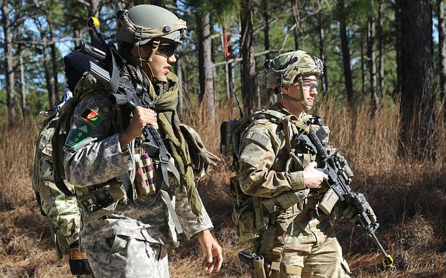 Capt. Justin M. Alexander, right, a combat advisor team leader for 1st Battalion, 1st Security Force Assistance Brigade, walks with an Afghan National Defense Security Forces role player during a simulated event at the Joint Readiness Training Center in Fort Polk, La., Jan. 13, 2018. The brigade has begun deploying to Afghanistan, according to the brigade Facebook page.