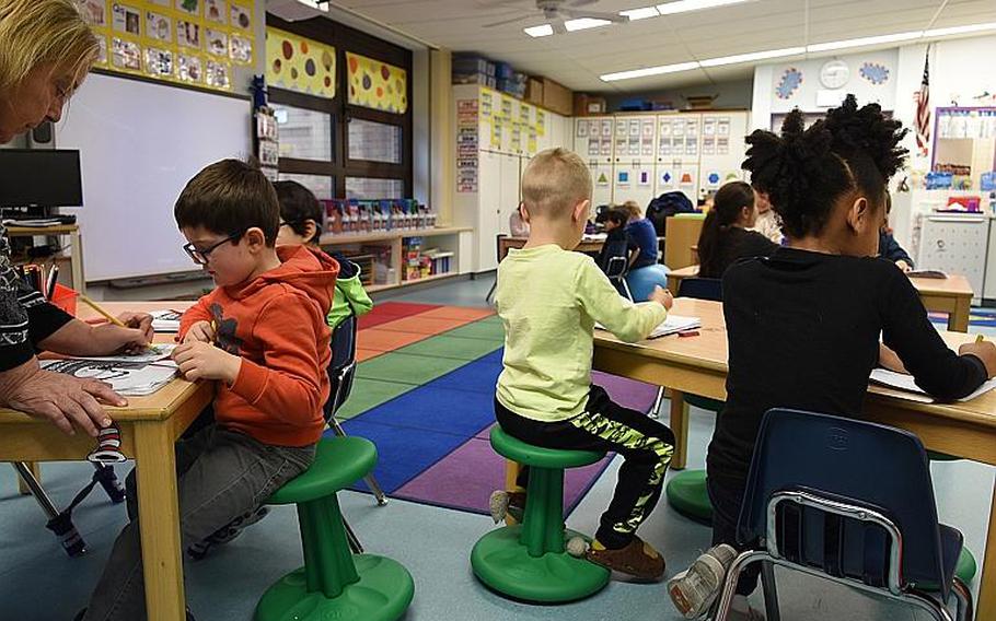 Teacher Kelli Keedwell works with her kindergarten students at Ramstein Elementary School, Germany on Jan. 22, 2018. Her classroom incorporates a variety of flexible seating, including wobbly stools that allow students to wiggle and move while doing class work.