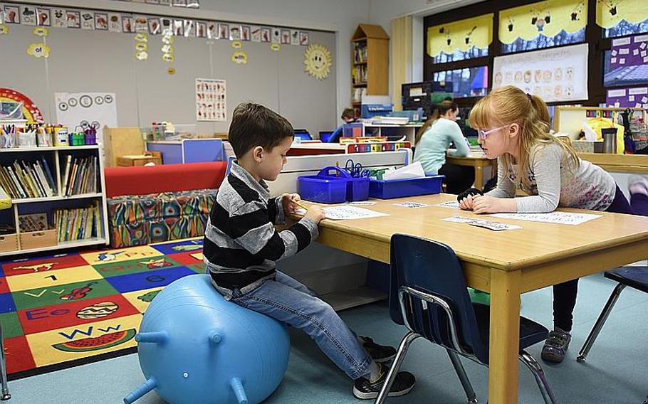 Kindergartners Blaine Denson and Makaylay Gile do classwork at Ramstein Elementary School, Germany. Denson sat on a yoga ball, one of several flexible seating options in his classroom.