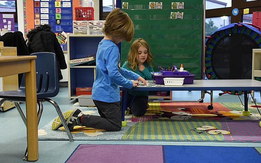 Kindergartners Jonah Winningham, left, and Aria Terrell have the option of sitting on the floor at a low table while doing work in their classroom at Ramstein Elementary School, Germany. At least a dozen classrooms at the school are using or are planning to use flexible seating.