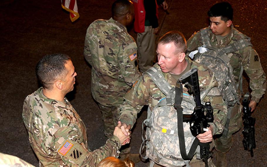 Brig. Gen. Sean Bernabe shakes hands with soldiers from the 1st Armored Brigade Combat Team, 3rd Infantry Division, at Fort Stewart, Ga., as they board a plane for South Korea earlier this month.