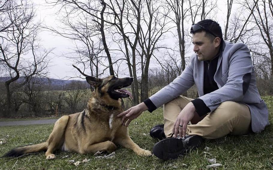 31p bs Tactical explosives detection dog Ben and his former handler, National Guardsman Julio Munoz, get reacquainted during their reunion in York, Pennsylvania in 2016. Ben's adopted owner Kim Scarborough sought out Munoz after she got the dog from the Army in 2014.
