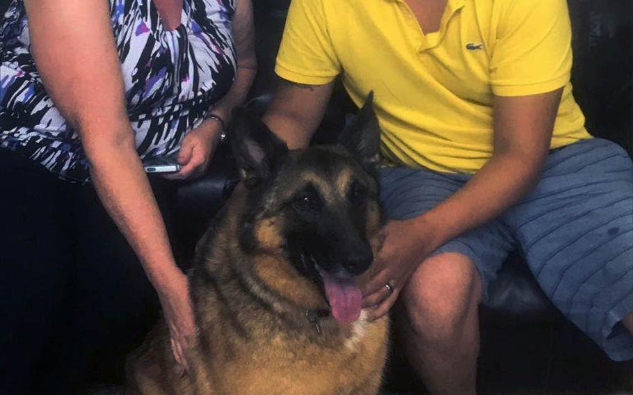 25p bs Kim Scarborough, right, tactical explosives detection dog Ben and Julio Munoz, his former handler, catch up at Scarborough's Kinston, North Carolina home in August 2017. Scarborough sought to reunite Ben and Munoz after she adopted Ben from the