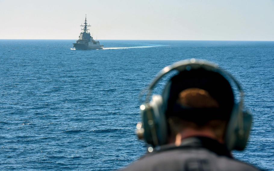 Seaman Jon Adams watches the Spanish frigate ESPS Cristobal Colon accompany the Arleigh Burke-class guided-missile destroyer USS Laboon during exercise Dynamic Manta 2018, March 11 in the Mediterranean Sea.