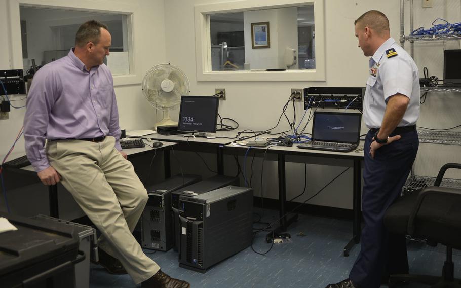Lt. Edward Costa, right, and Michael Galicki discuss the challenges of the Windows 10 upgrade Wednesday, Feb. 14, 2018.