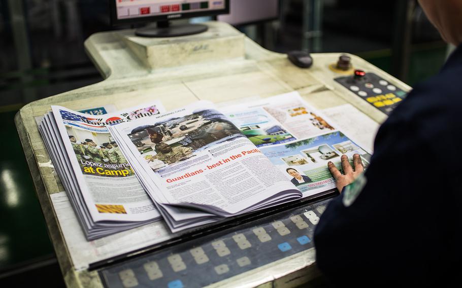 A Morning Calm newspaper is inspected at a printing press at Bucheon, South Korea, Wednesday, March 21, 2018.