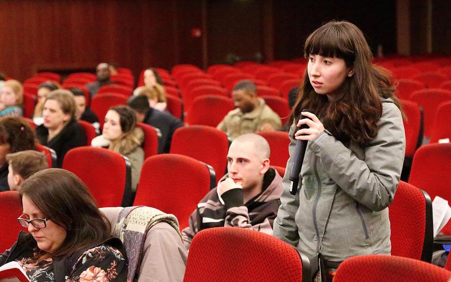 An Army spouse asks post officials in Baumholder, Germany, to identify what the unidentified solid flecks are in the water at the family housing units on post, during a town hall meeting at Smith Barracks on Tuesday, March 20, 2018.