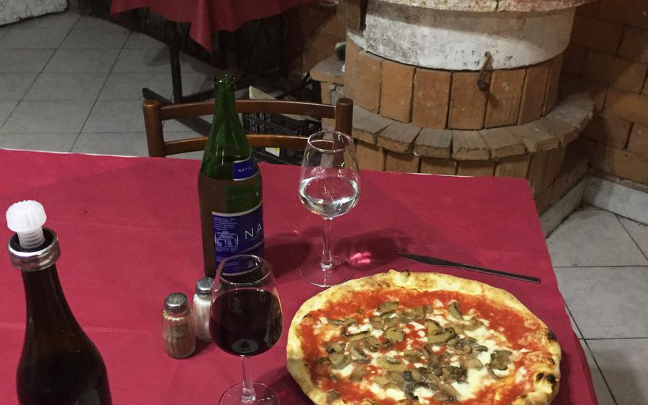 A fire crackling in a marble hearth creates a warm atmosphere while you dine at Ristorante Pizzeria Il Pentolone. Located in the Parco Azzurro apartment complex, it is off the beaten path in Pozzuoli, Italy.