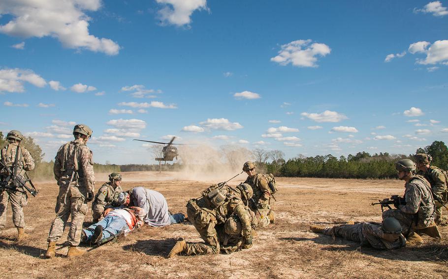 Soldiers with the Army's 1st Security Force Assistance Brigade, center, and role players portraying Afghan villagers and soldiers tend to wounded individuals as an American HH-60 Black Hawk medical evacuation helicopter lands to pick up the injured. The scenario was part of a mission rehearsal exercise Jan. 15 for the 1st SFAB, which was preparing for its spring deployment to Afghanistan.