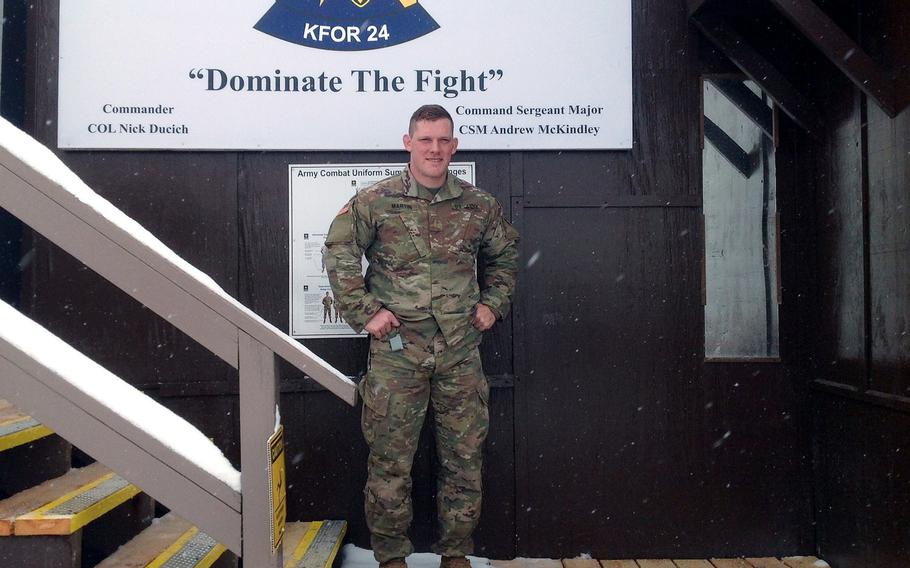 2nd Lt. Adam Martin of Fort Carson, Colo., a liaison officer with NATO's Kosovo Force, stands in front of the unit's guard post at Camp Bondsteel on Thursday, March 22, 2018. The 19-year mission has assumed greater prominence since a series of incidents between bitter rivals Serbs and Albanians.