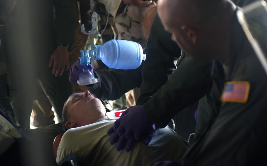 Airmen assigned to the 167th Aeromedical Evacuation Squadron, run through a simulated medical emergency in a C-130H Hercules, assigned to the West Virginia Air National Guard's 130th Airlift Wing, at Captain Andalla Cissé Air Base, Senegal, March 22, 2018.