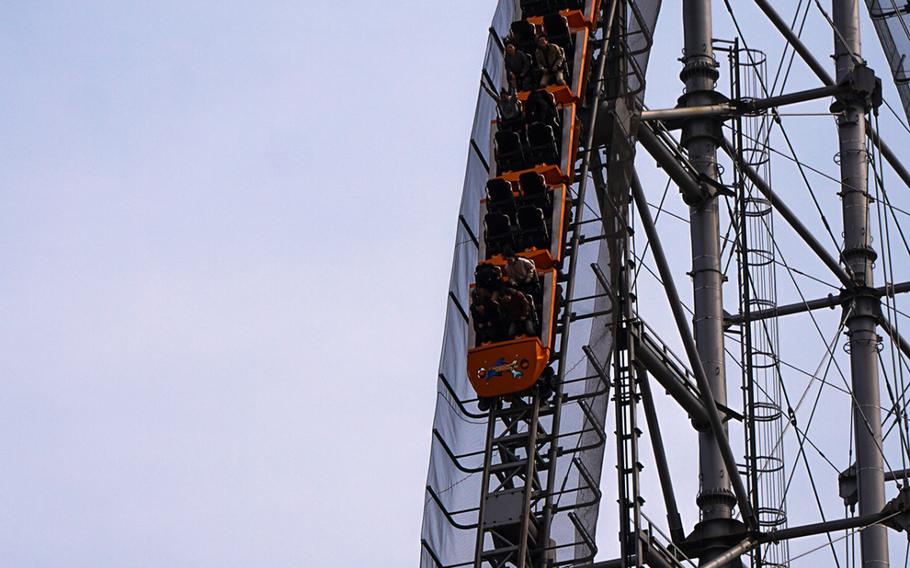 Riders take the plunge on Thunder Dolphin's 218-foot, 80-degree first drop at Tokyo Dome City Attractions in the heart of Tokyo.