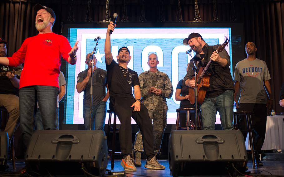 Gen. Paul Selva, vice chairman of the Joint Chiefs of Staff, sings with celebrities during a USO show at Osan Air Base, South Korea, Monday, April 23, 2018.