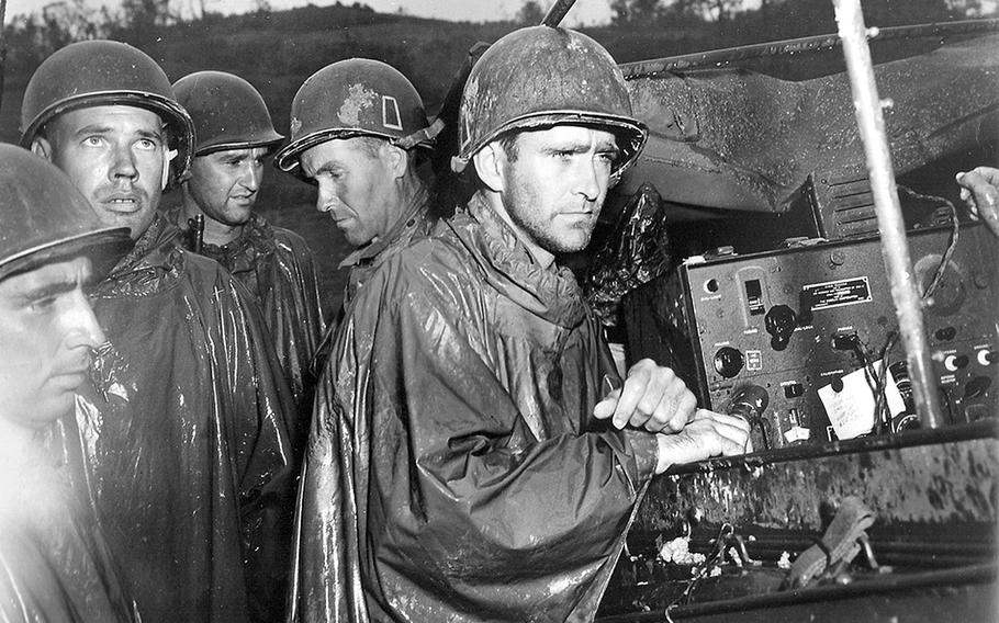 A group of soldiers take a break from fighting in Okinawa to listen to reports of Germany's surrender on May 8, 1945. Moments after the announcement, the men returned to the fighting against the Japanese. The American Soldier in WWII, a history project directed from Virginia Tech, is converting microfilm of surveys from WWII soldiers into a searchable internet database.