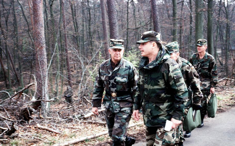 Gen. Crosbie E. Saint, left, former commander of U.S. Army Europe and 7th Army, talks with an officer as he tours the scene of a simulated chemical accident during an exercise in Germany on Aug. 21, 1990. Saint, 81, died on May 7, 2018.