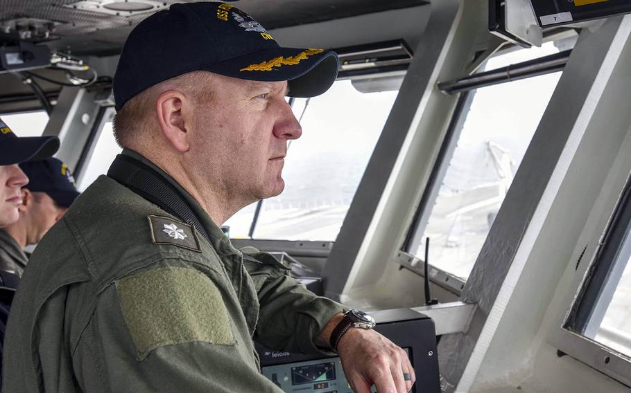 Cmdr. Stephen Weeks, navigator aboard the USS Ronald Reagan, monitors the aircraft carrier's course as it returns to Yokosuka Naval Base, Japan, after sea trials, Thursday, May 17, 2018.