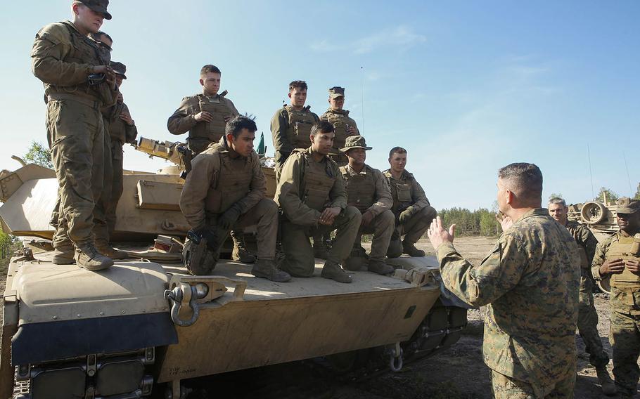 Col. John J. Carroll, the deputy commander of Marine Forces Europe and Africa, talks to Marines with 2nd Platoon, Company B., 4th Tanks from the state of Washington during Exercise Arrow 18 in Pohjankangas Training Area, Finland, May 15, 2018.