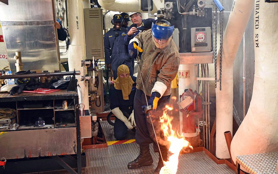 Petty Officer 3rd Class Leonard Barnes prepares to light the One Bravo boiler aboard the USS Blue Ridge at Yokosuka Naval Base, Japan, Tuesday, May 22, 2018.