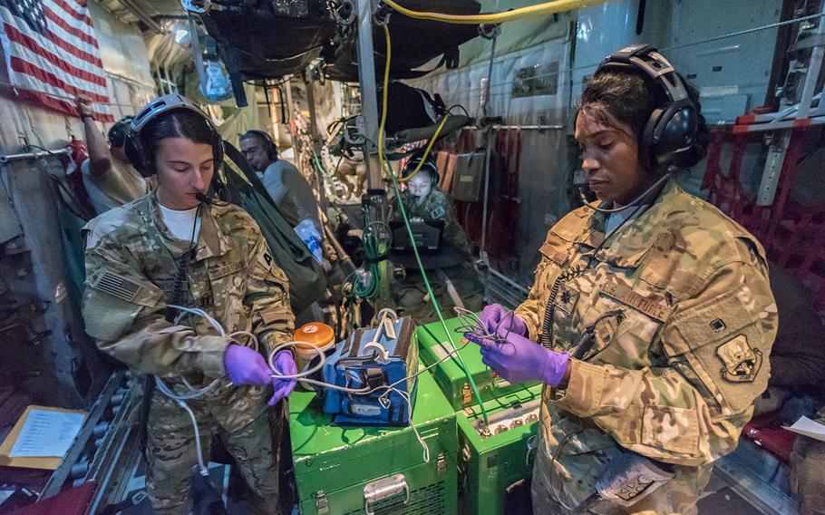 U.S. Air Force Lt. Col. Deveril Wint, right, medical crew director, and Capt. Elise Cunningham, a flight nurse, both with the 379th Expeditionary Aeromedical Evacuation Squadron, pack equipment after a mission to pick up patients in Afghanistan, at Al Udeid Air Base, Qatar, Nov. 25, 2017.