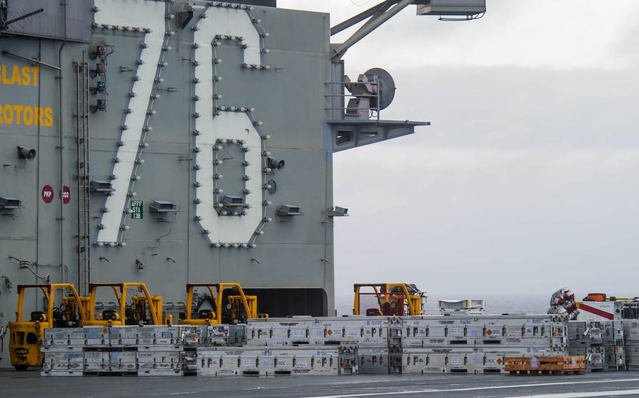 The aircraft carrier USS Ronald Reagan takes part in a replenishment at sea in waters south of Japan, May 14, 2018.