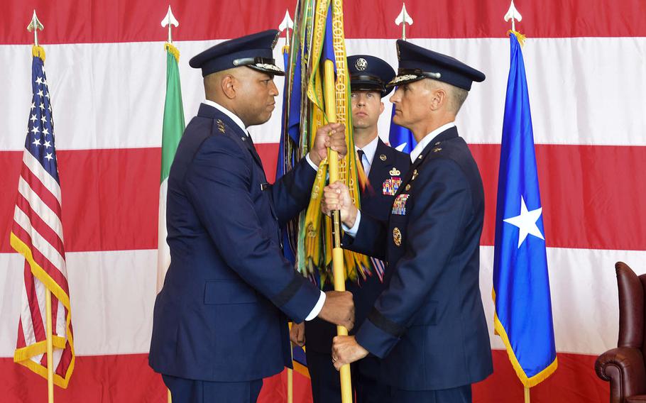 Lt. Gen. Richard Clark, left, the 3rd Air Force commander, hands the 31st Fighter Wing guidon to Brig. Gen. Daniel Lasica, 31 Fighter Wing commander, during a change-of-command ceremony at Aviano Air Base, Italy, Thursday, June 21, 2018. 