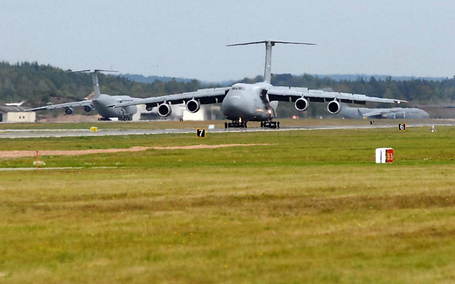 A C-5 Galaxy rolls down the Ramstein Air Base, Germany, runway, as a C-17 Globemaster III, right, and another C-5 wait to take off. The U.S. is said to be considering a large reduction of troops in Germany, which could involve sending many troops back to the U.S.